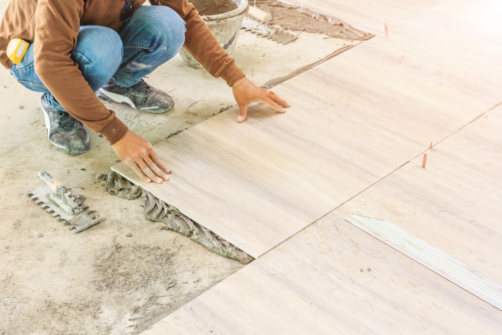 home-improvement-renovation-construction-worker-tiler-is-tiling-min